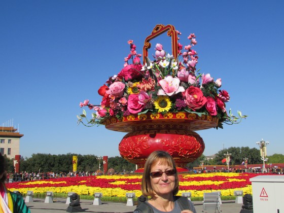 Sarah balancing a bouquet of flowers on her head in T Square Beijing when the sky was still blue..