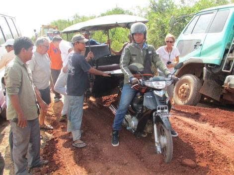 Then a motorbike tuk tuk gets stuck going through the middle