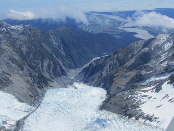 Looking down to the west coast of New Zealand - in the far distance, cloud envelopes the seashore